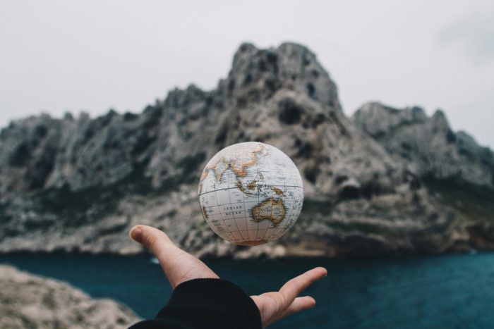 hand holding a floating globe symbolising an international divorce
